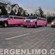 Pink Hummer limousines parked outside a house. Perfect for a 21st birthday celebration!
