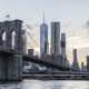 Brooklyn Bridge with NYC skyline at sunset.