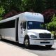White party bus parked on a paved road