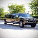 Black Hummer limousine parked on a paved driveway
