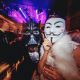 Couple at party in Darth Vader and Anonymous masks
