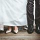 Bride and groom's feet and shoes; her champagne heels, his black oxfords.