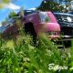 Pink and black Cadillac Escalade limousine parked in grass