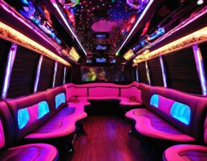 Interior of a luxurious pink party bus with LED lighting, perfect for a Sweet Sixteen in New Jersey.