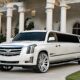 White Cadillac Escalade limousine parked in front of a mansion. Perfect for a Bergen Limo wedding.