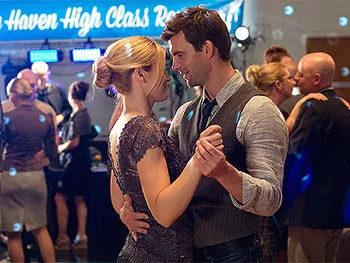 Couple slow dancing at a high school reunion