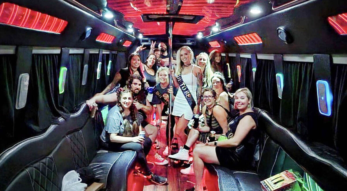 Bride-to-be and friends celebrating on a party bus during a bachelorette party.