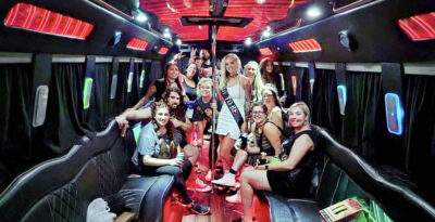 Bride-to-be and friends celebrating on a party bus during a bachelorette party.