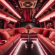 Romantic Valentine's Day party bus interior with heart-shaped balloons, rose bouquets, and a table set for two.
