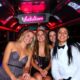 Happy bachelorette party group in a party bus, celebrating with Batullari