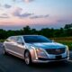 Luxury silver limousine on open road.