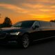 Black limo at sunset landscape.